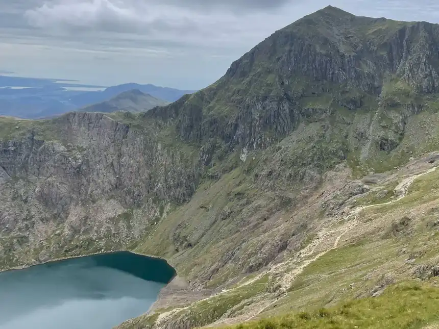 The view from high on Yr Wyddfa in August, a lake far below in the valley