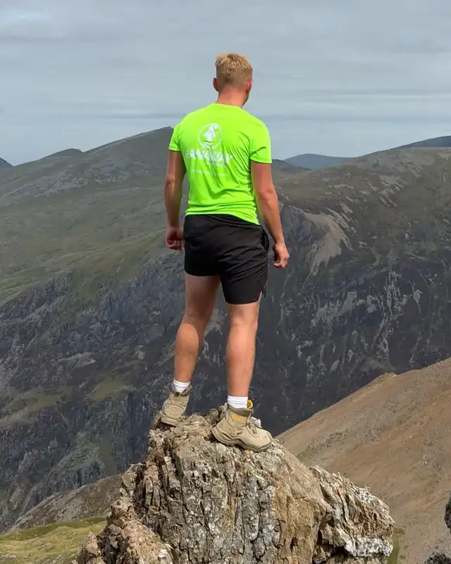 The green Lanaway shirt on a rock outcrop high on Yr Wyddfa